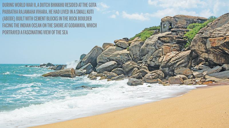 The turbulent sea below the rocky boulder on the sea shore