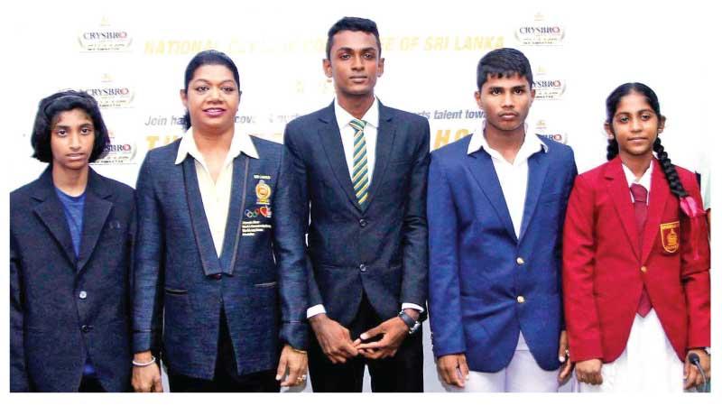 From left: Tharushi Karunaratne (athletics), Susanthika Jayasinghe, Ravindu Jayasundara (athletics), Deshan Kumara (weight lifting) and Sachini Laksarani (weight lifting) pose for a photo on the historic occasion (Pic by Sulochana Gamage)    