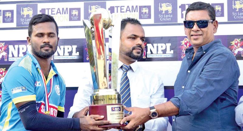 Skipper of the Jaffna Gladiators S. Niroshan receiving the Champion trophy from   Sri Lanka Cricket vice president Ravin Wickramaratne