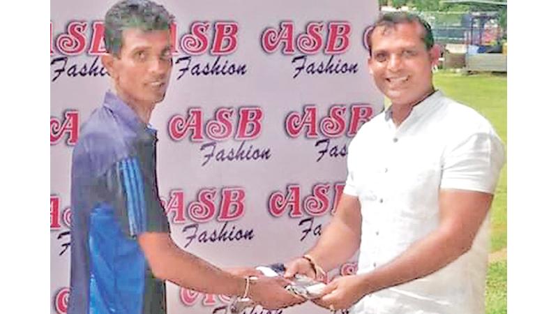 PIW Jayasekara a senior Ccicket coach receiving an official T-shirt and Membership card from Asanka Prasad, Director of ASB Fashion    
