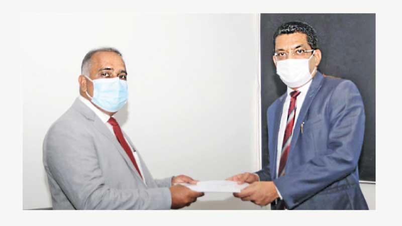 Minister of Justice Ali Sabry PC presents the appointment letter to Attorney-at-Law Ganesh R. Dharmawardana