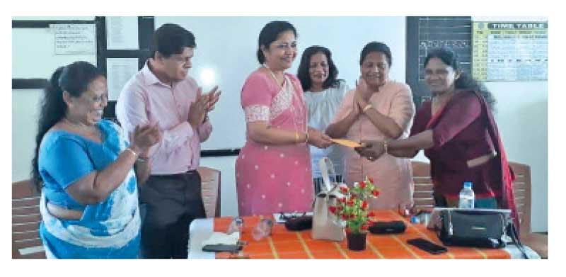 Lakshmi Victoria (3rd from left) presenting the sponsorship to Kalutara district netball coach Janaki Gunasekara during the coaching development program. Netball secretary Champa Gunawardena (left) is also in the picture    