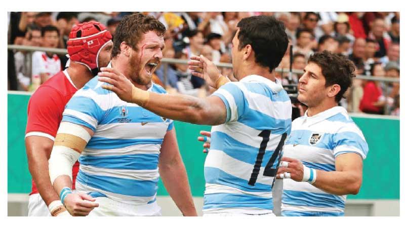 File photo of Julian Montoya (L) of Argentina celebrates scoring