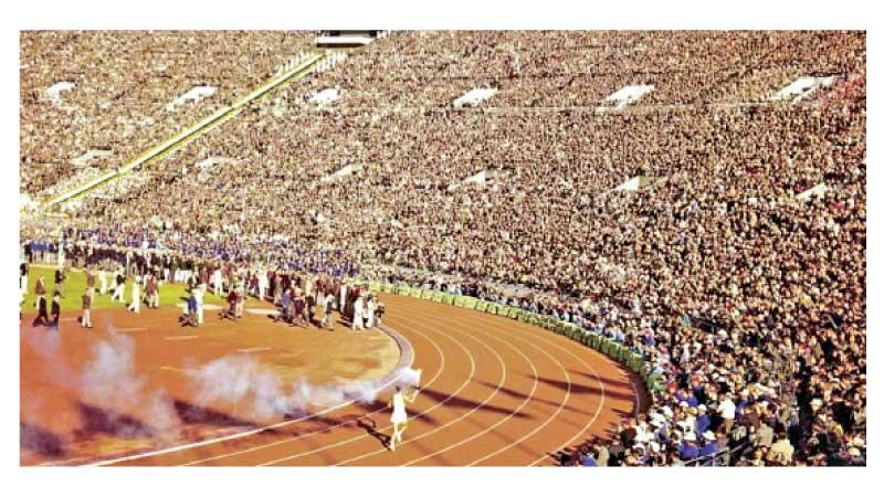 Yoshinori Sakai running with the Flame to the Olympic Cauldron  