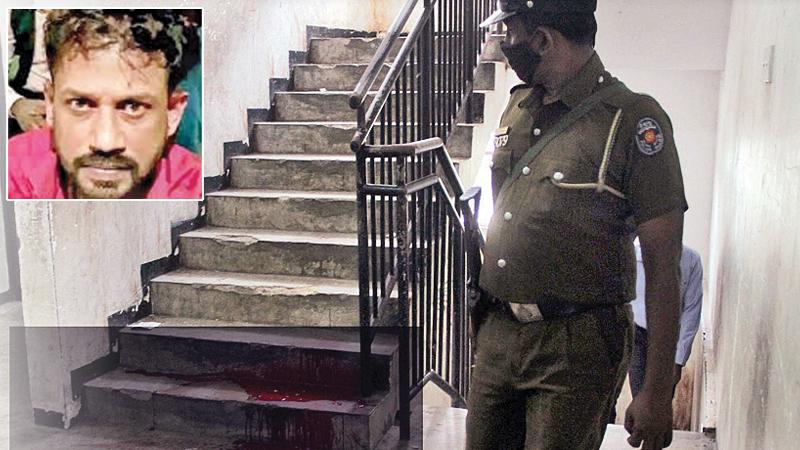 A policeman inspecting the apartment in Maligawatta