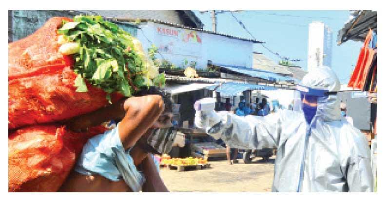 Testing body temperature at the Manning Market.  Pic: Hirantha Gunathilake