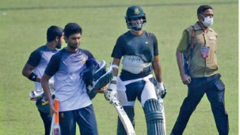 Shakib Al Hassan is escorted by an armed guard