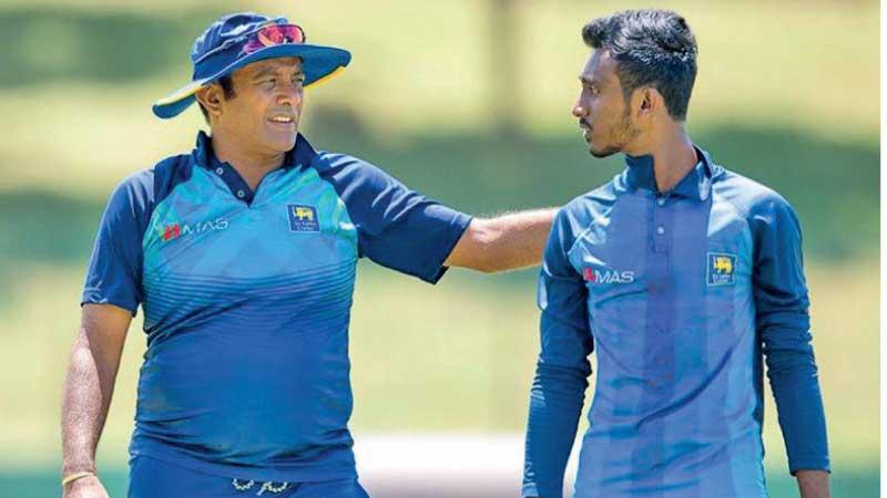 Hashan Tillekeratne talks to a young player