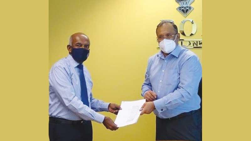 Managing Director of Tokyo Cement Company (Lanka) PLC, S.R. Gnanam and  Chairman of the BOI, Susantha Ratnayake exchange the agreement.