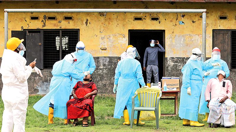 Rapid antigen tests being conducted by health officials at De Mel Watte in Grandpass. (Pic: Rukmala Gamage)