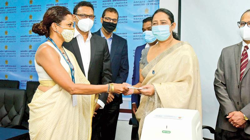 Hemas CEO Kasturi Chellaraja Wilson presents the machine to Health Minister Pavithra Wanniarachchi.