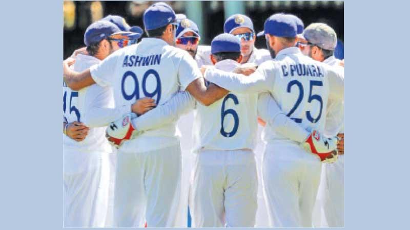 The Indian team huddle together before taking the field for the final session of the third day of the third cricket Test against Australia in Sydney