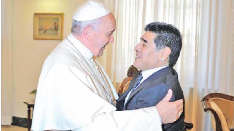 Pope Francis who was once a football goal keeper during his youth in Argentina meets fellow Argentine legend Diego Maradona in this file photo during a Vatican audience