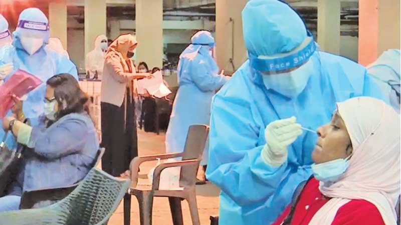 Sri Lankan migrant workers undergo tests for Covid-19 at the Bandaranaike International Airport.