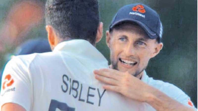 England captain Joe Root hugs his batsman Dom Sibley after winning the second Test in Galle