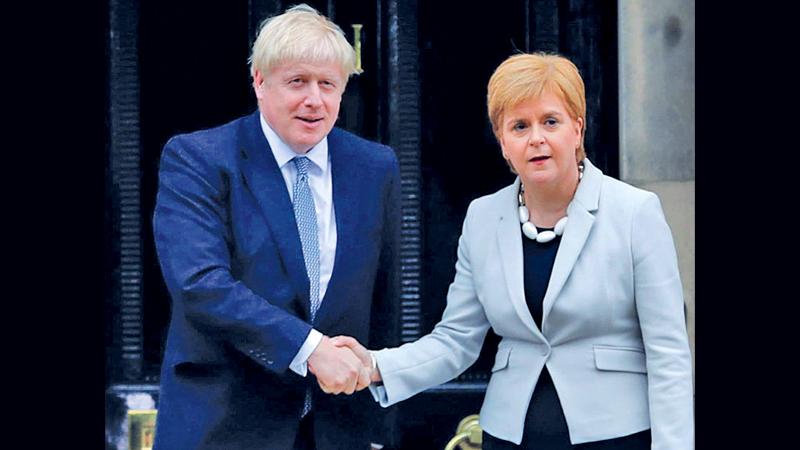 Scotland’s First Minister Nicola Sturgeon welcomes Prime Minister Boris Johnson outside Bute House in Edinburgh