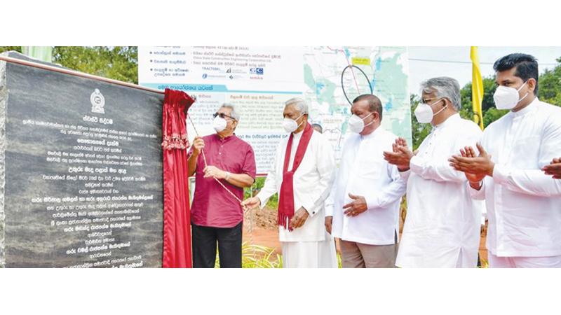 President Gotabaya Rajapaksa unveils the plaque of the proposed irrigation tunnel flanked by ministers and other officials