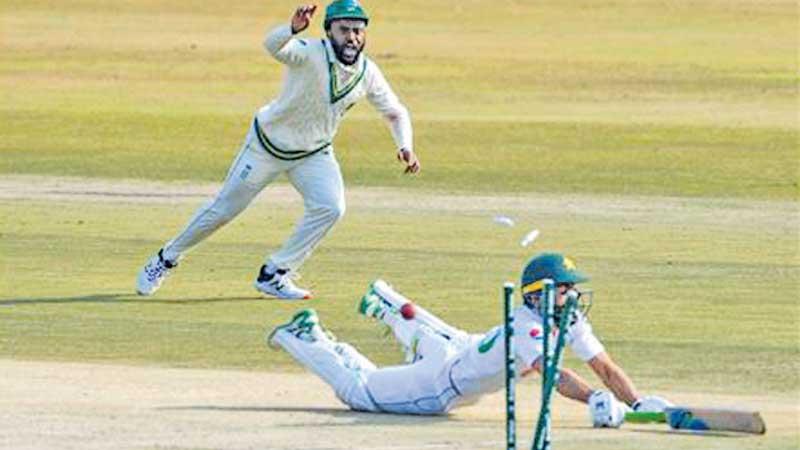 Temba Bavuma (L) celebrates running out Fawad Alam -AFP