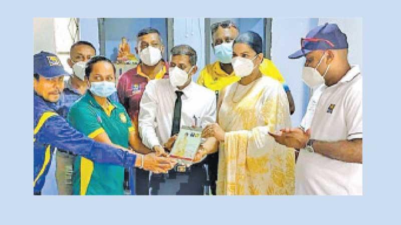 Women’s cricket convenor Apsari Tillekaratne receiving a special plaque from Kolonna National School Principal, staff members and coaches during the talent search program in the Sabaragamuwa province