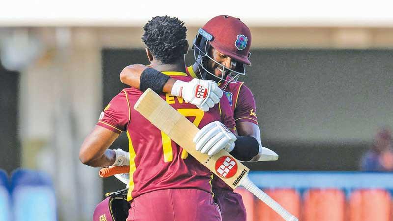 Shai Hope congratulates Evin Lewis on his century