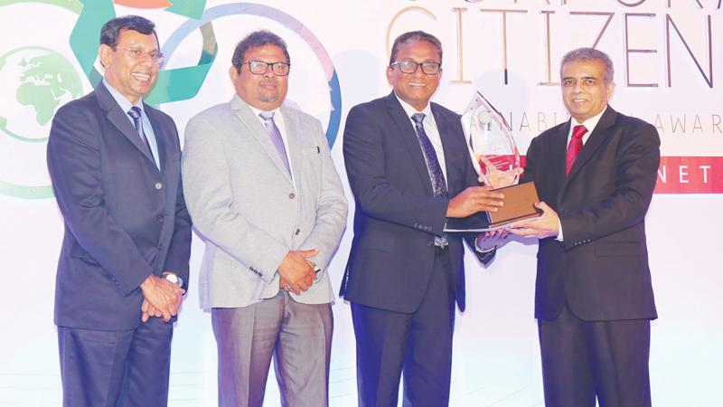 Chairman, Ceylon Chamber of Commerce, Dr. Hans Wijayasuriya presents one of the awards to SLT CEO  Kiththi Perera. (From left): Head of Judging Panel, Dr. Ananda Mallawatantri and SLT COO Priyantha Fernandez look on.