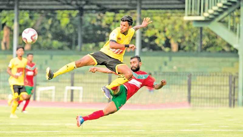 File photo of Colombo Football Club (in yellow) and New Youngs Wennappuwa (red) in action during their warm-up match ahead of the Super Premier League scheduled to start on April 18