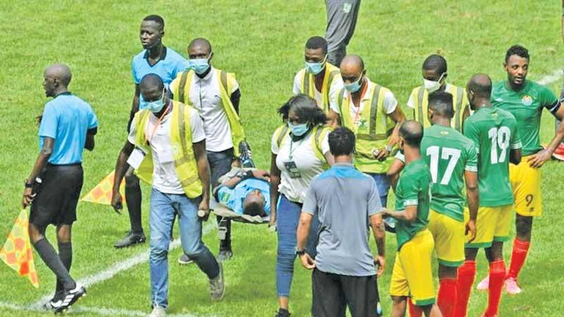 Ghanaian referee Charles Bulu who collapsed 80 minutes into a Group K match in Abidjan is taken to hospital on a stretcher