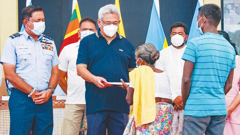President Gotabaya Rajapaksa presents a gift to an elderly woman