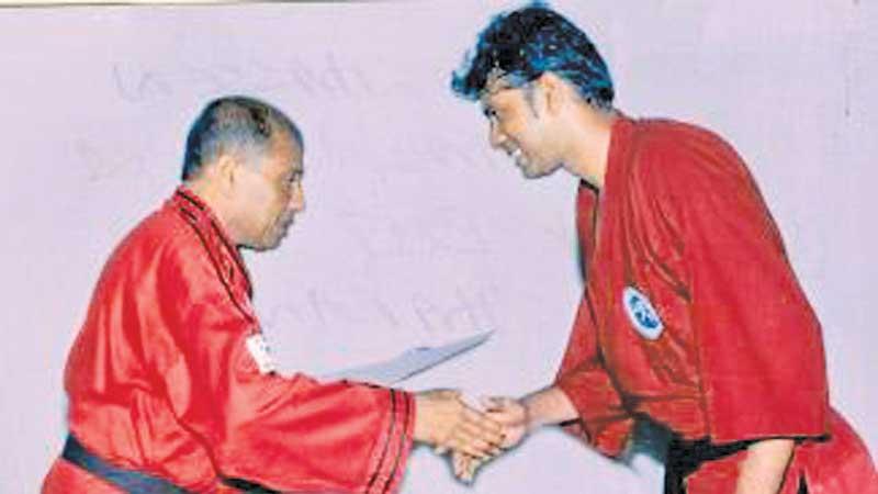 File photo of Hassen Khalid (left) presenting the black belt to T. Rangatharan
