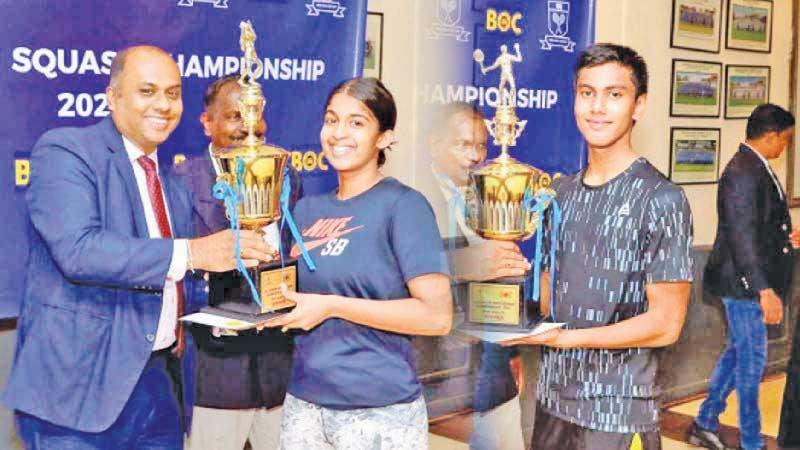 Yehani Kuruppu and Ilham Osmone receiving the champions trophy from the chief guest Rajith Thushantha