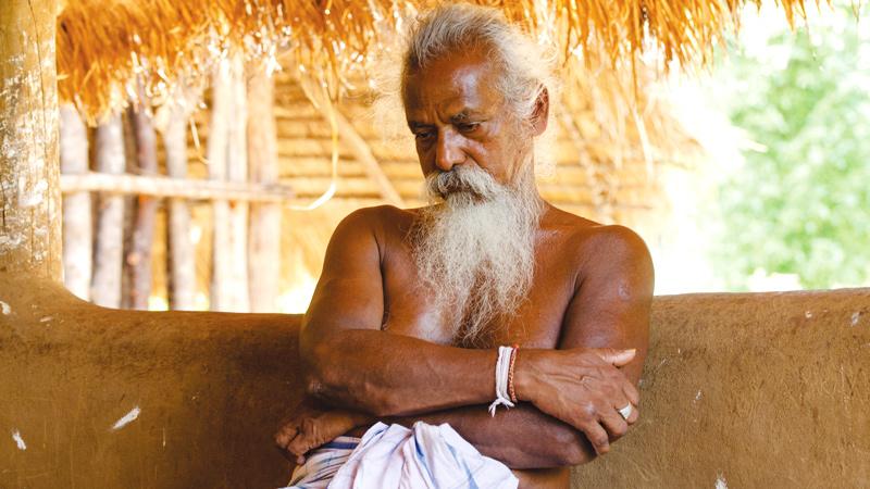Veddha Chief Uruwarige Wannila-etto in his home at Kotabakiniya