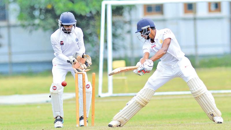 Ahan Wickremasinghe of Royal College looks behind to see his stumps shattered in their match against Wesley College at Reid Avenue yesterday (Pic. by Chinthaka Kumarasinghe)