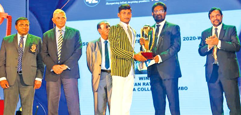 Pawan Ratnayake of Mahanama College receiving the Division One Schoolboy Cricketer award from Minister of Information and Media Keheliya Rambukwella