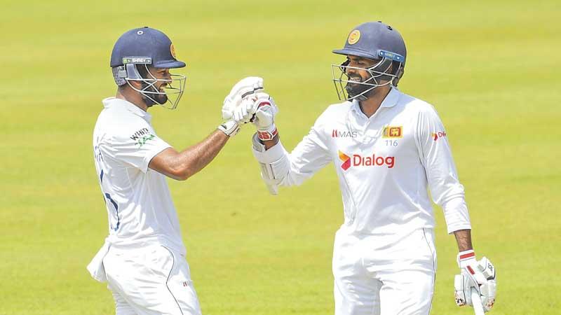 Dimuth Karunaratne (left) and Lahiru Thirimanne, both century-makers in the current second cricket Test against Bangladesh share a moment in Pallekele