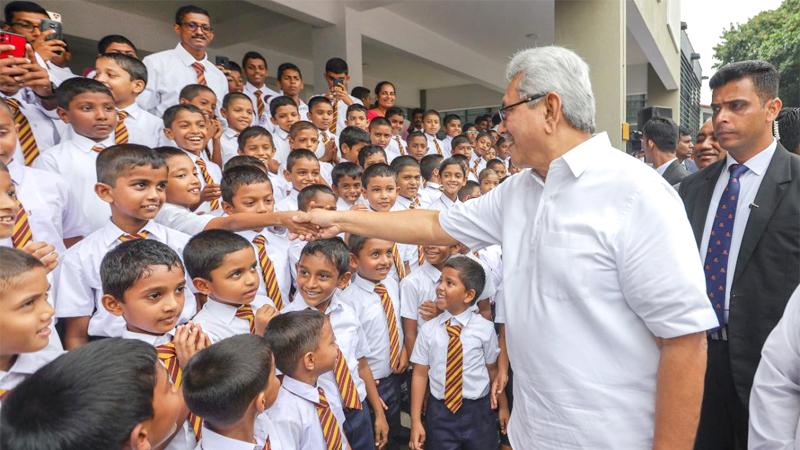President Gotabaya Rajapaksa greets a student during the Gama Samaga Pilisandara program.