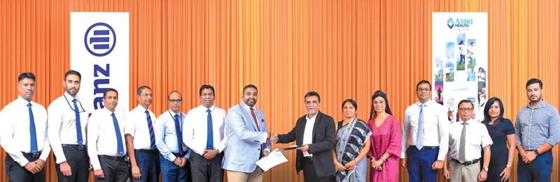 CEO, Asiri Hospitals, Dr. Manjula Karunarathne (seventh from right) presents the partnership agreement to CEO, Allianz Insurance, Gany Subramaniam.