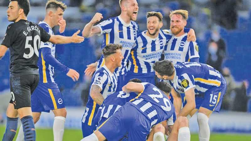 Brighton players celebrate their stunning win over Manchester City