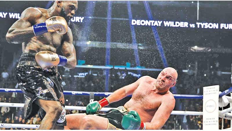 Wilder knocks down Fury in this file photo