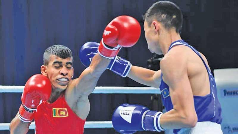 Kazakhstan’s Saken Bibossynov parries a left jab from Lasindu Eranda