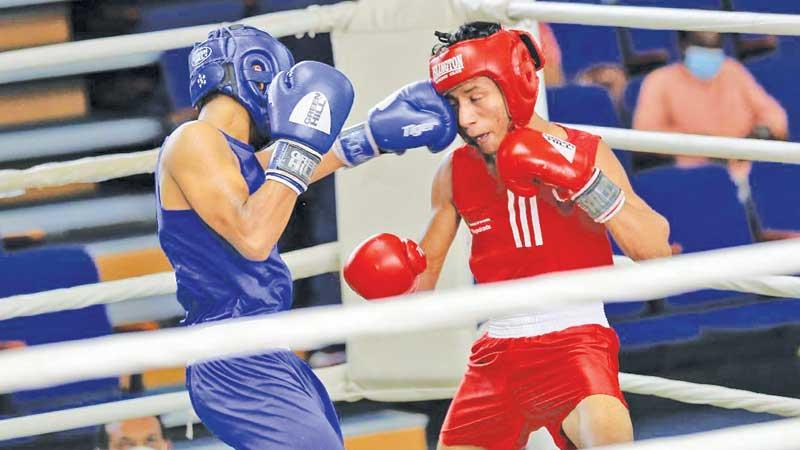 Pasindu Mihiran landing a left hook on J.I.D. Ratnayake (Pic by Rukmal Gamage)