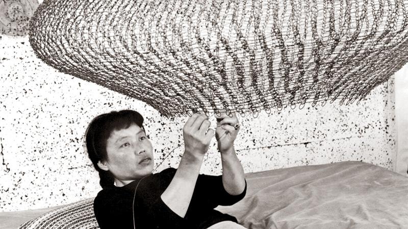Portrait of Ruth Asawa forming a looped-wire sculpture, 1957. Photo by Imogen Cunningham. © 2019 Imogen Cunningham Trust. Courtesy of the Imogen Cunningham Trust