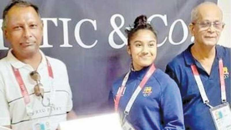 Sri Lanka gymnast Milka de Silva receiving the modern massage kit from NOC President Suresh Subramaniam in the presence of its Secretary Maxwell de Silva