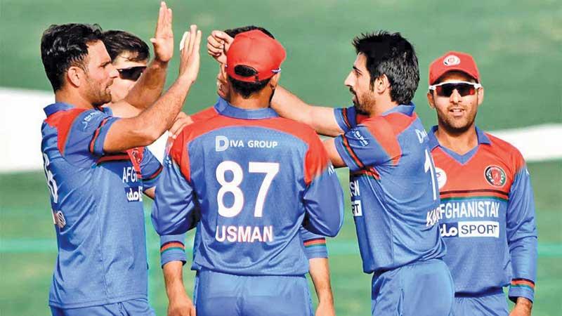 Members of the Afghanistan team come together during a match in this file picture