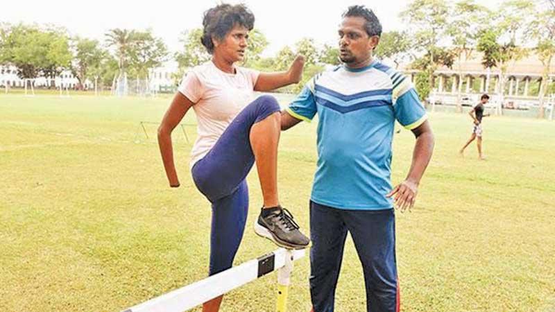 Harijan Ratnayake giving instructions to Para Olympic athlete  Kumudu Priyanka during a training session