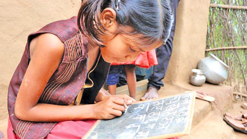 Radhika, 10, struggles to write the alphabet after 17 months of being out of school