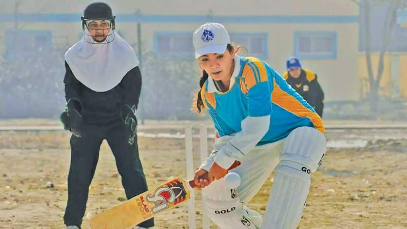 A girl in Afghanistan plays cricket