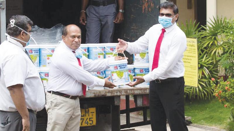 Dr. Amal Harsha de Silva receives the paint