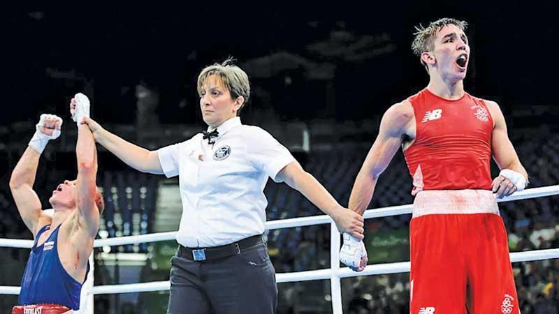 Michael Conlan of Ireland (right) reacts following his defeat to Vladimir Nikitin of Russia during the 2016 Rio Olympics