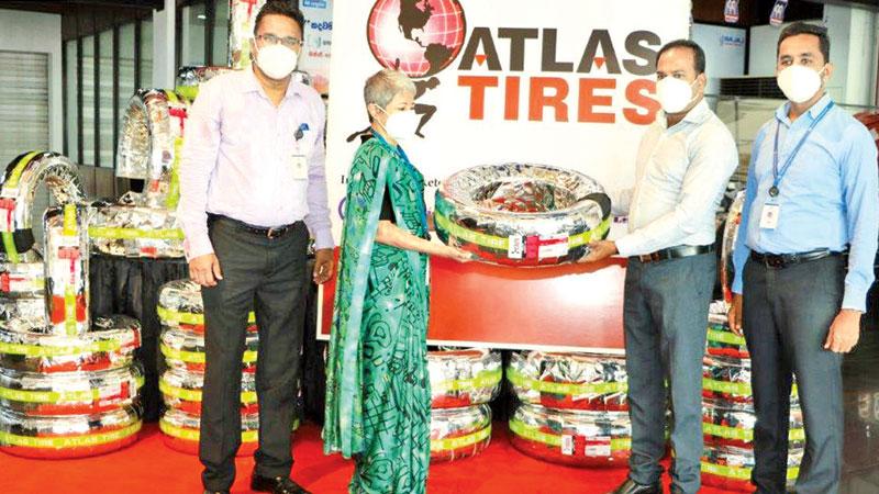 DPMC Director Mrs Romany Parakrama presents an Atlas tyre to one of the first customers.