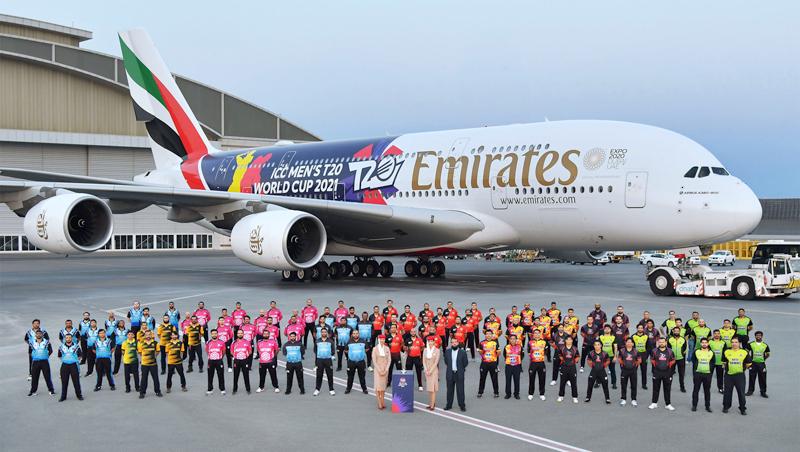 The vibrant decal covering the Emirates A380 fuselage includes pink and yellow figures batting and bowling against a purple backdrop.